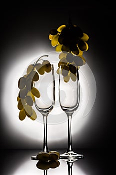 Two empty glasses and grapes