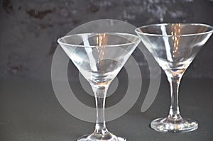 Two empty glasses for making margarita cocktails with lime on a black background Margarita cocktails shot on a bar