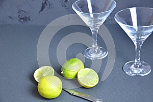 Two empty glasses for making margarita cocktails with lime on a black background Margarita cocktails shot on a bar
