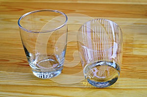 Two empty glasses on a wooden table top view