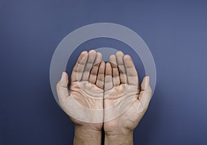 Two empty holding hands gesture  on blue background.