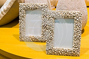 Two empty photo frames on table