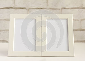 Two empty photo frames on a table or shelf with a copy of the space