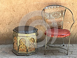 Two empty, quirky, worn metallic chairs in street, Marrakech, Morocco