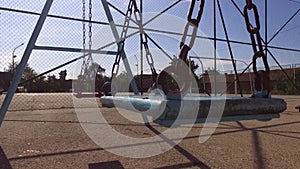 Two Empty Swings for Kids in the Summer
