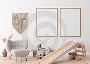 Two empty vertical picture frames on white wall in modern child room. Mock up interior in scandinavian, boho style. Free