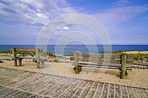 Empty wooden bench on pathway access sandy beach in cap ferret atlantic coast in france