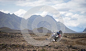 Two enduro Motorcycle standing on a dirt road in the desert surrounded by mountains on the Laugavegur trail, Iceland