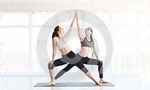 Two energy girls doing yoga and practise different exercises
