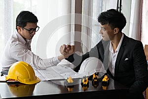 Two engineer or businessman engage in arm wrestling
