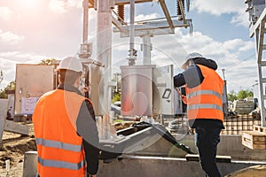 Two engineer electricians check the substation construction process