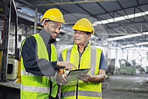two engineer look projects and planning with tablet mobile in factory