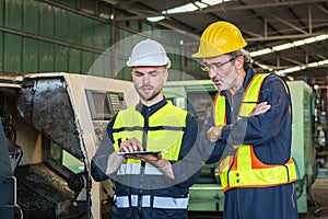 two engineer look projects and planning with tablet mobile in factory