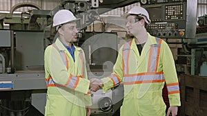 Two engineer man and friend work and greeting with agreement and success together in factory industrial.