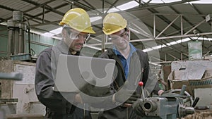 Two engineer man training work with laptop computer together in factory industrial.