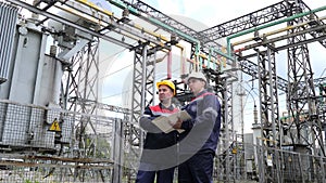 Two engineer working on checking and maintenance equipment of the substation. Power engineering