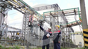 Two engineer working on checking and maintenance equipment of the substation. Power engineering