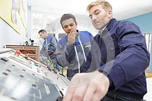 two engineering control room checking process photo