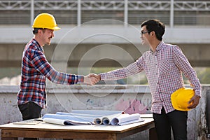 Two engineers shaking hands
