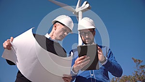 Two engineers discussing a blueprint