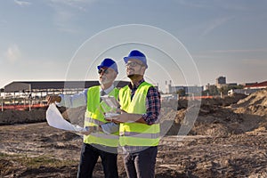 Construction engineers with drone at building site