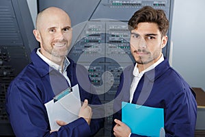 two engineers looking at camera