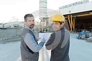 two engineers looking at camera at plant site