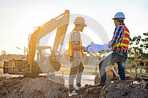 Two engineers are planning the road construction