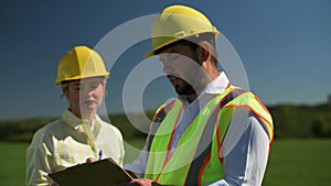 Two engineers talk about the project for the construction of a renewable energy solar panels