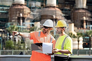 Two engineers workers, industry factory workers outdoor. Factory operators, mechanical engineering team production