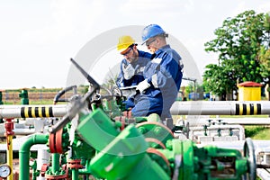 Two engineers working inside oil and gas refinery