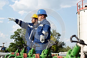 Two engineers working inside oil and gas refinery