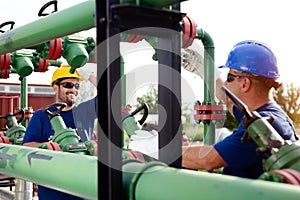 Two engineers working inside oil and gas refinery