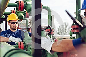 Two engineers working inside oil and gas refinery