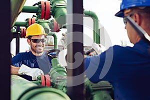 Two engineers working inside oil and gas refinery