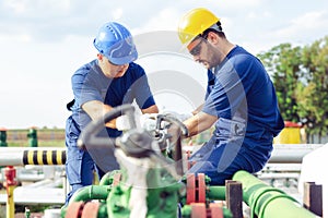 Two engineers working inside oil and gas refinery