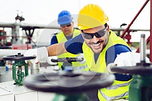 Two engineers working inside oil and gas refinery