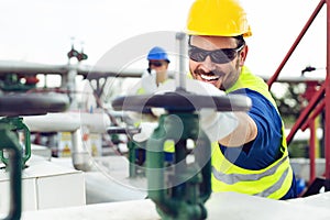 Two engineers working inside oil and gas refinery