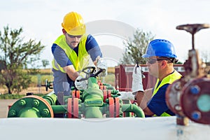 Two engineers working inside oil and gas refinery