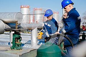 Two engineers working inside oil and gas refinery