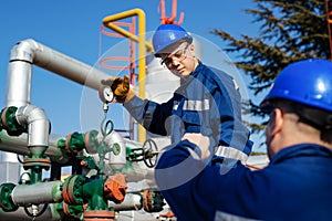 Two engineers working inside oil and gas refinery