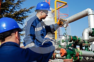 Two engineers working inside oil and gas refinery