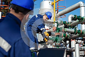 Two engineers working inside oil and gas refinery