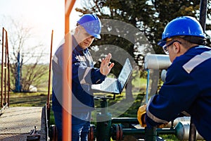 Two engineers working inside oil and gas refinery