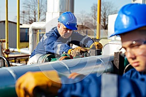 Two engineers working inside oil and gas refinery