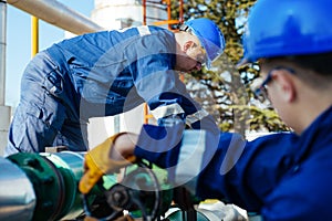 Two engineers working inside oil and gas refinery