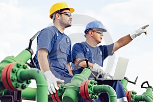 Two engineers working inside oil and gas refinery photo