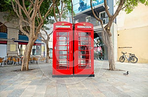 Two English red telephone boxes on street at downtown. Gibraltar