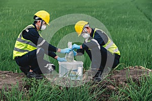 Two Environmental Engineers Take Water Samples at Natural Water Sources Near Farmland Maybe Contaminated by Toxic Waste or