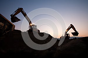 Two escavators working on a mine